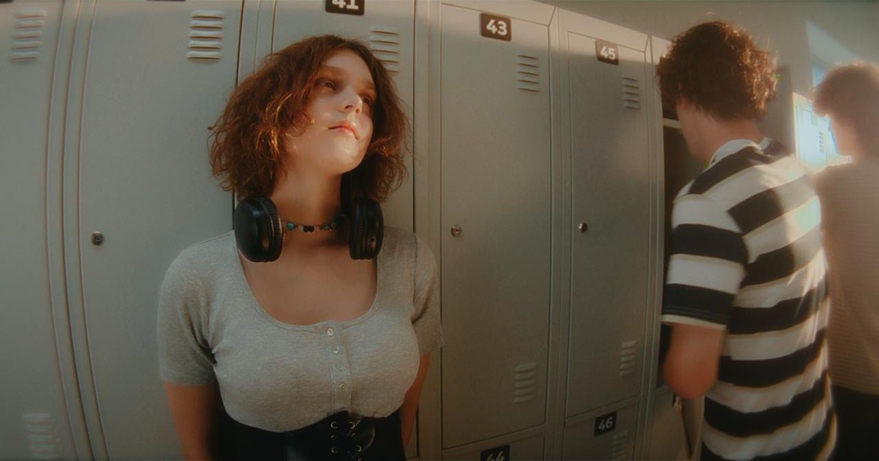 A girl leaning against school lockers